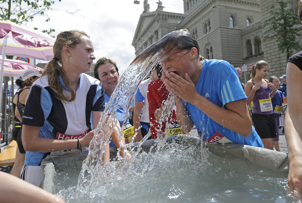 young man dunking his head in water