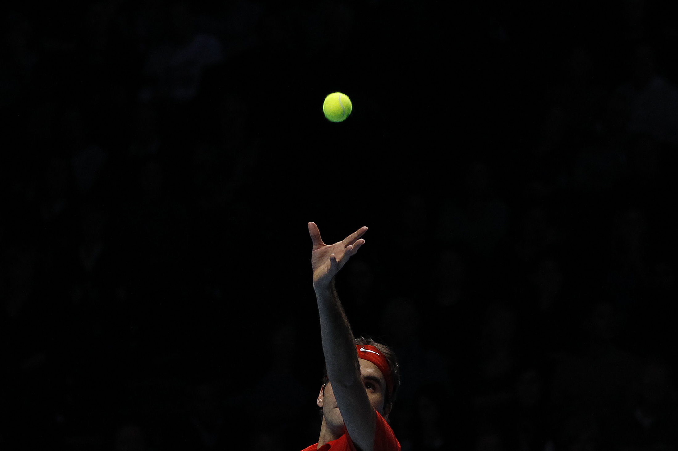 لاعب كرة مضرب يرفع الكرة قبل ضربها