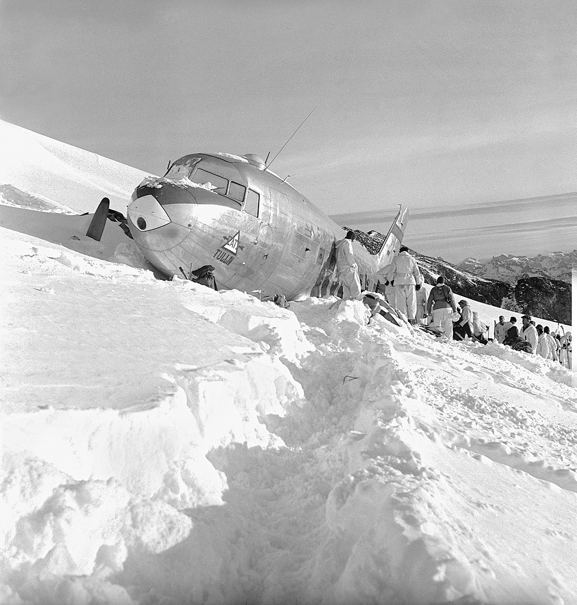 people and plane in snow