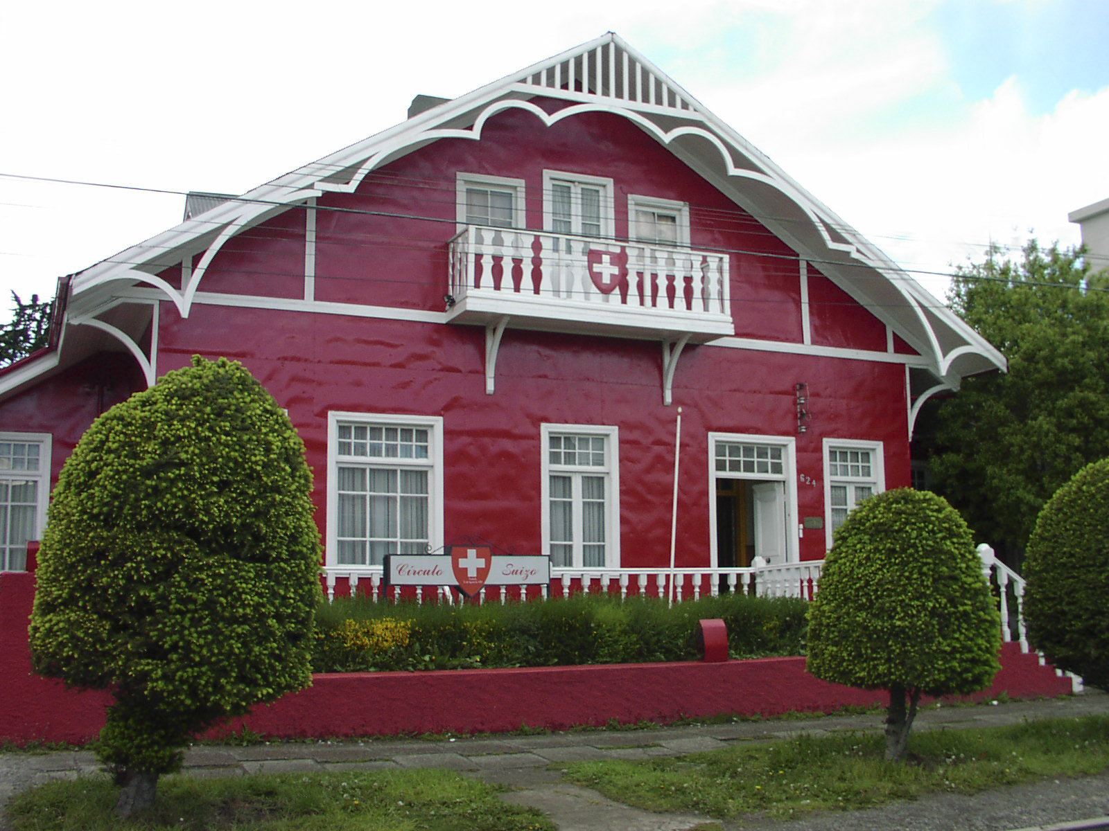 Swiss style Red chalet with swiss flag as decoration. represent Swiss Citizen living abroad
