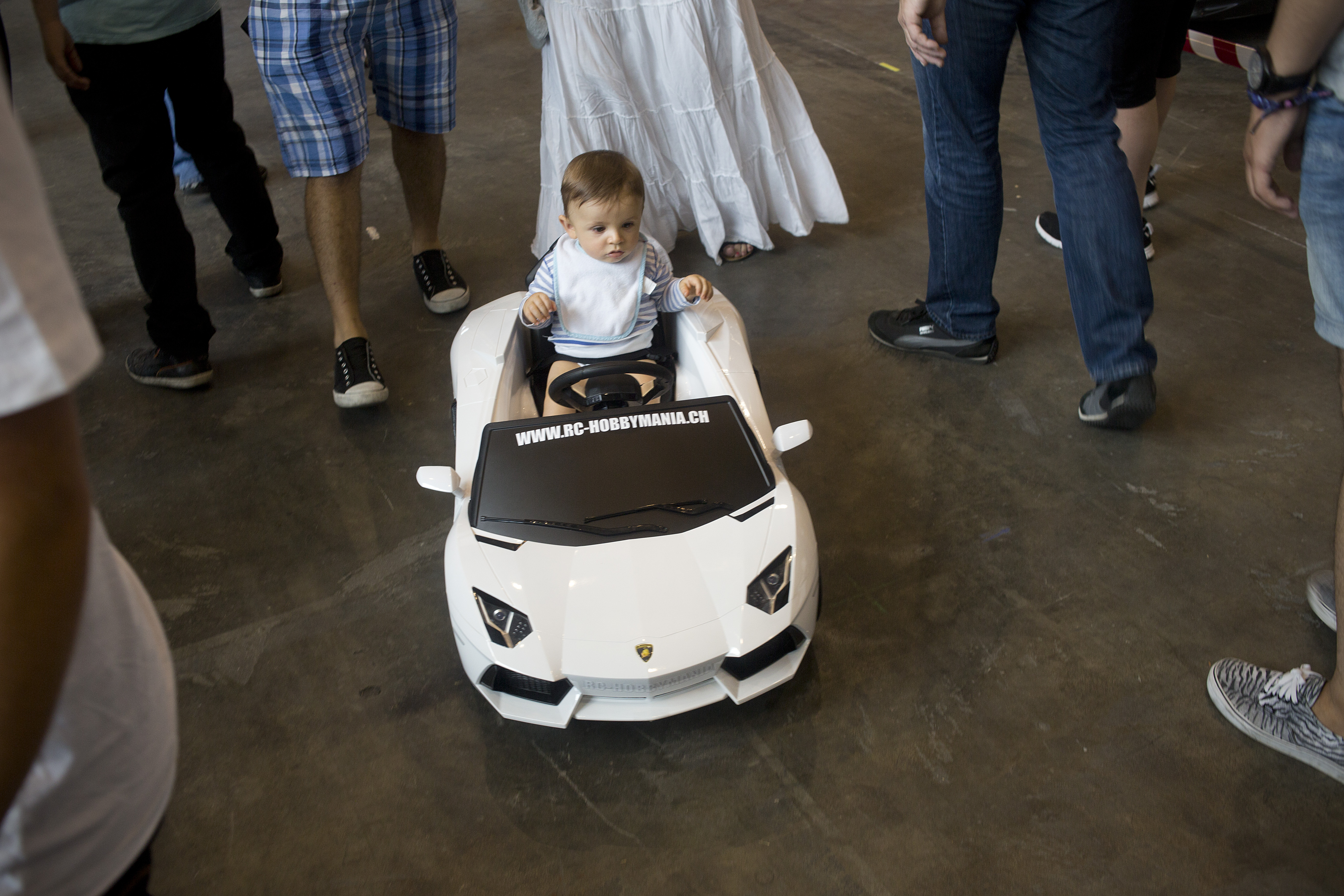 A baby in a toy car