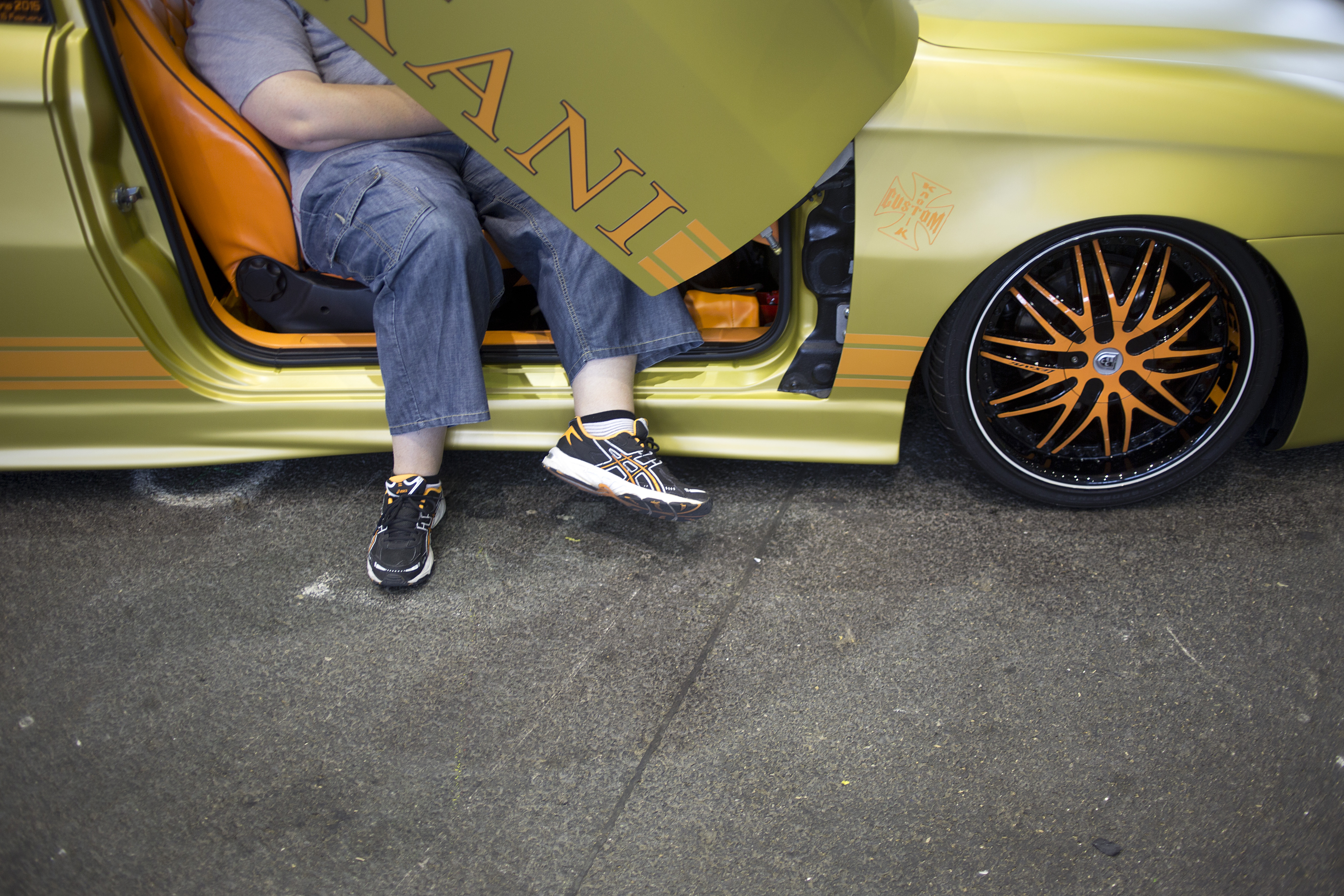 A visitor sits on a car seat