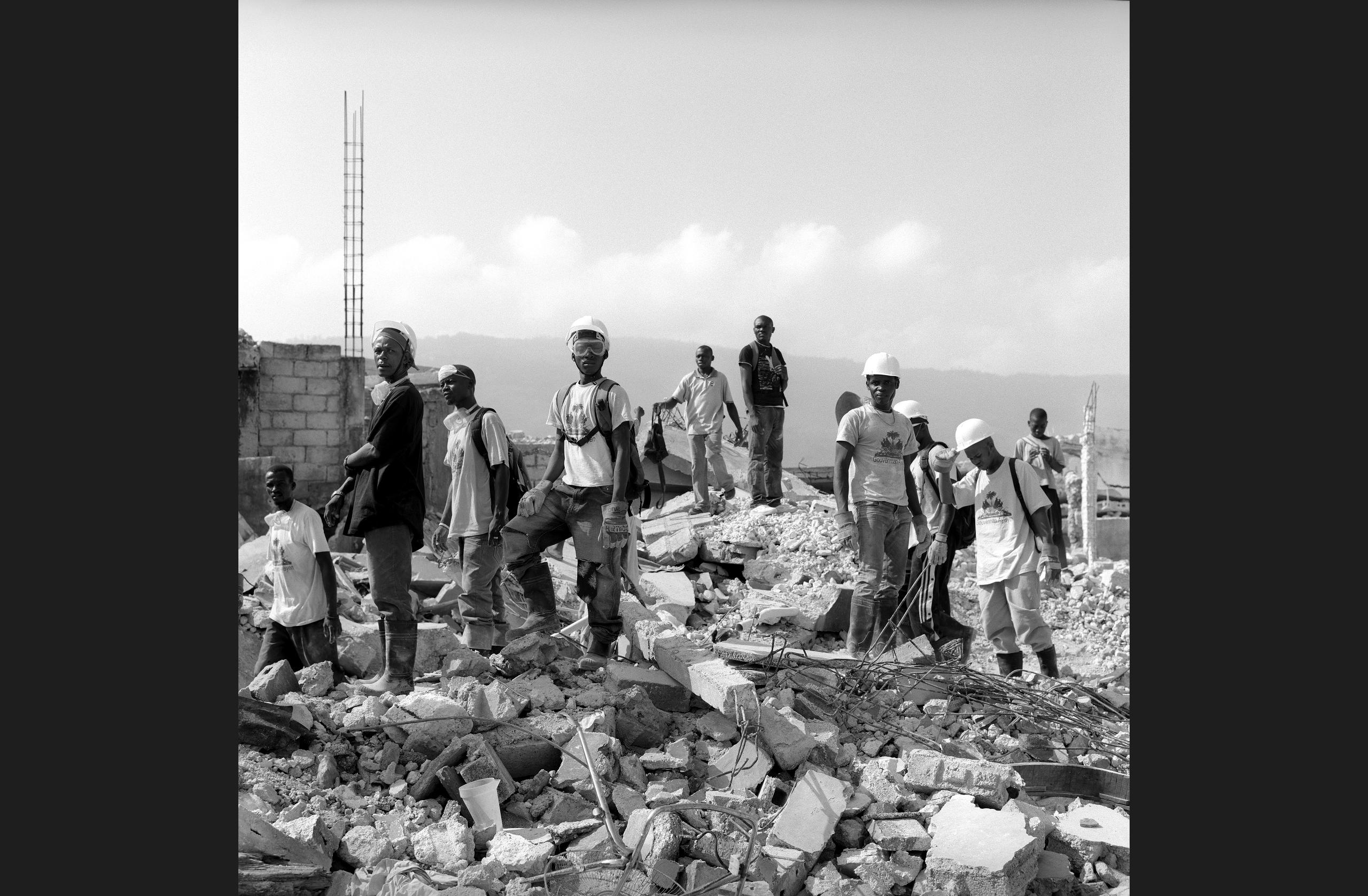 Local residents cleaning up rubble