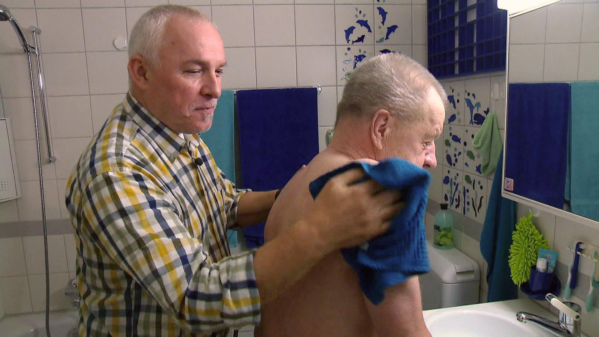A man from the gay homecare service washes an old man