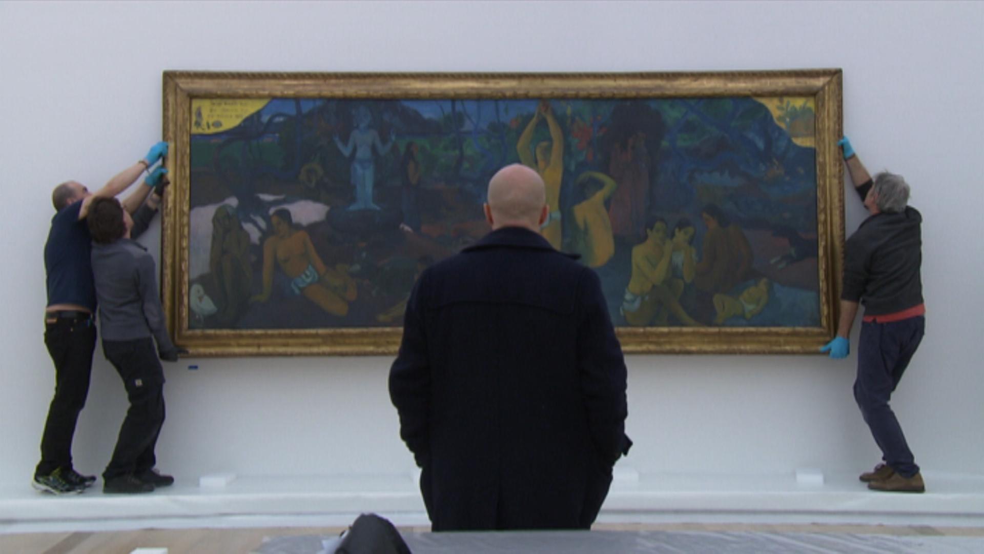 Art handlers, specially trained museums technicians, hang up a picture of Gauguin in the Beyeler Foundation in Basel