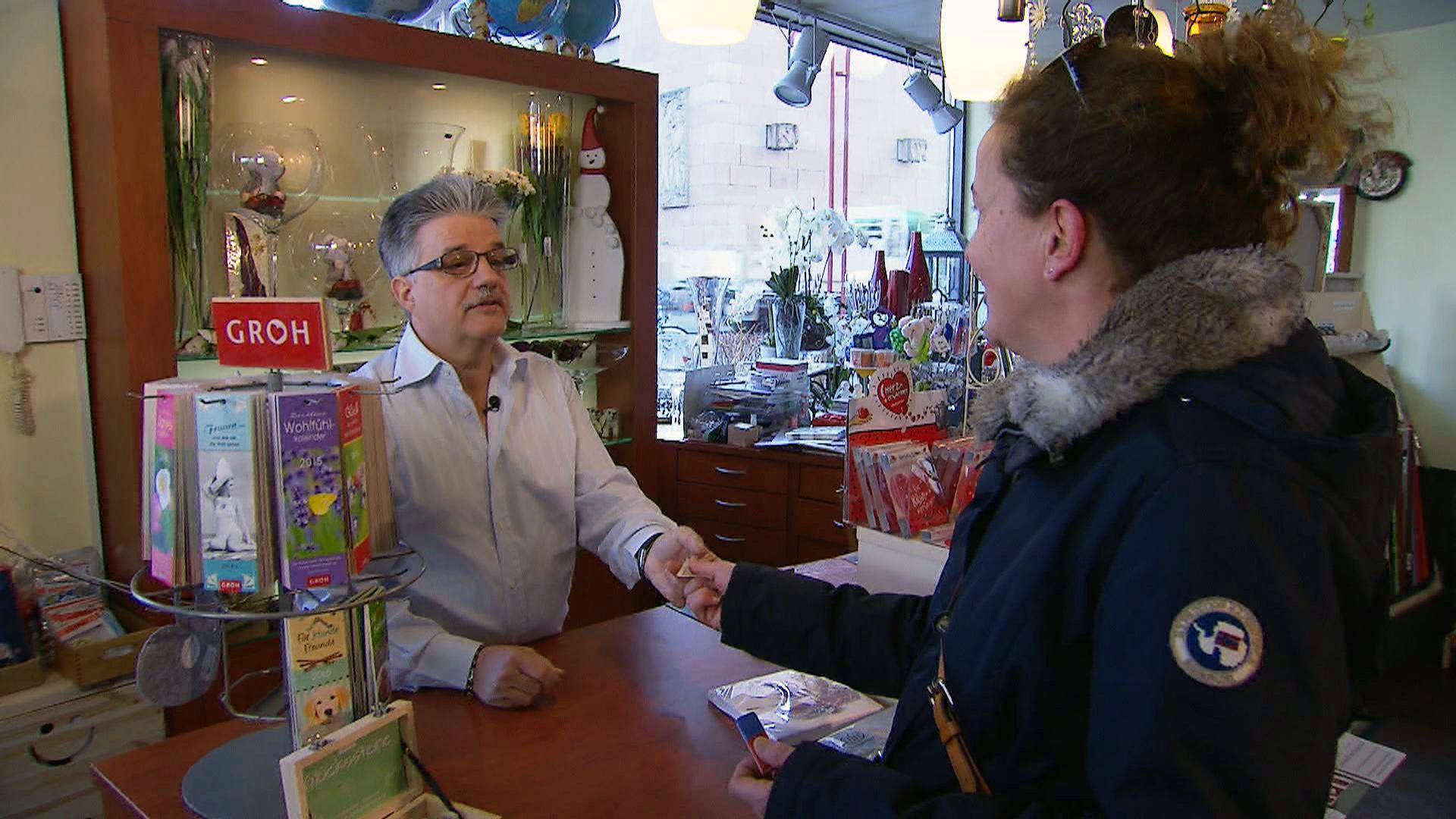 A woman pays for her purchases in a shop