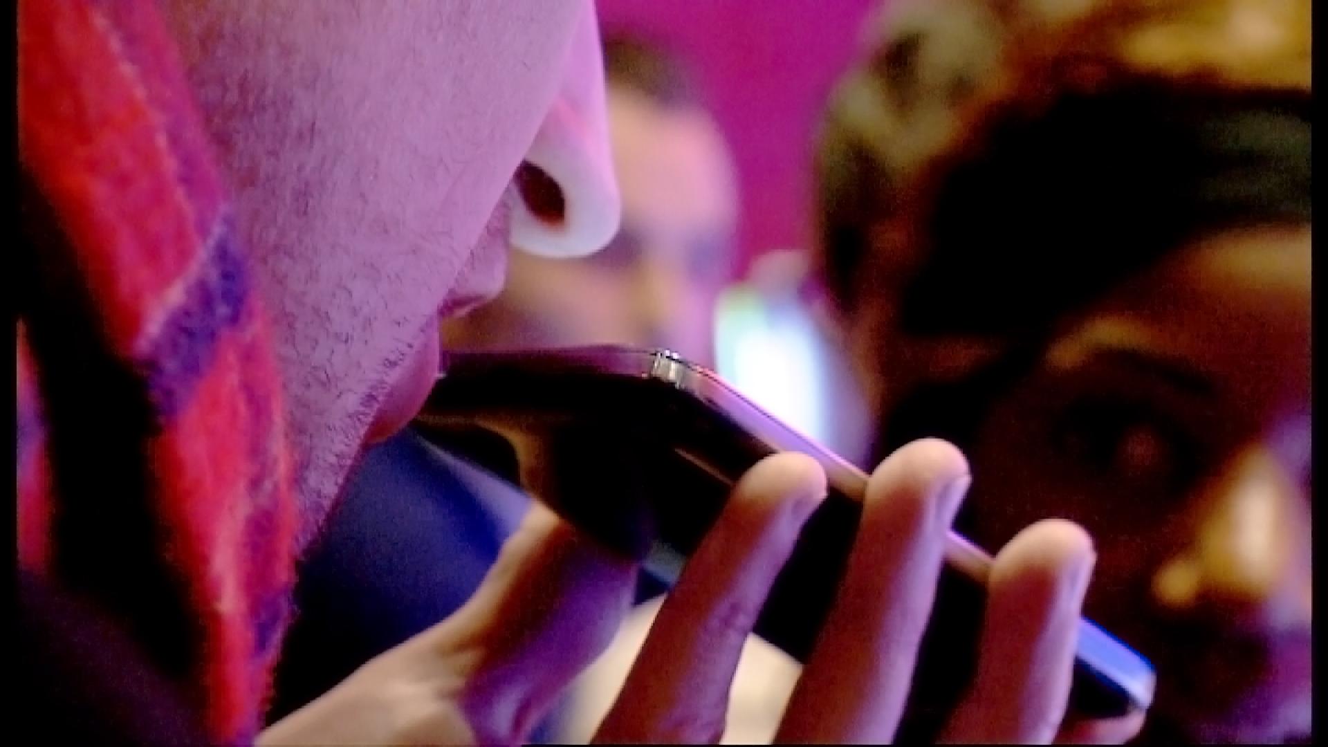 A man breathes into a smartphone