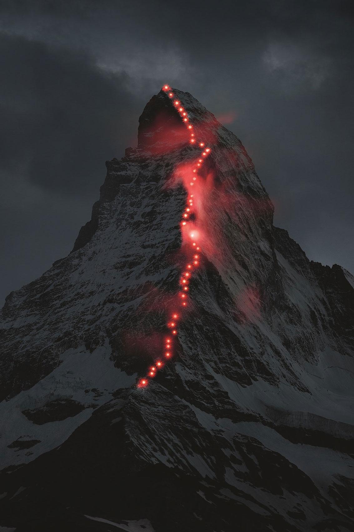Lamps illuminate the path of the first ascent on the famous Matterhorn mountain, in Zermatt, Switzerland.