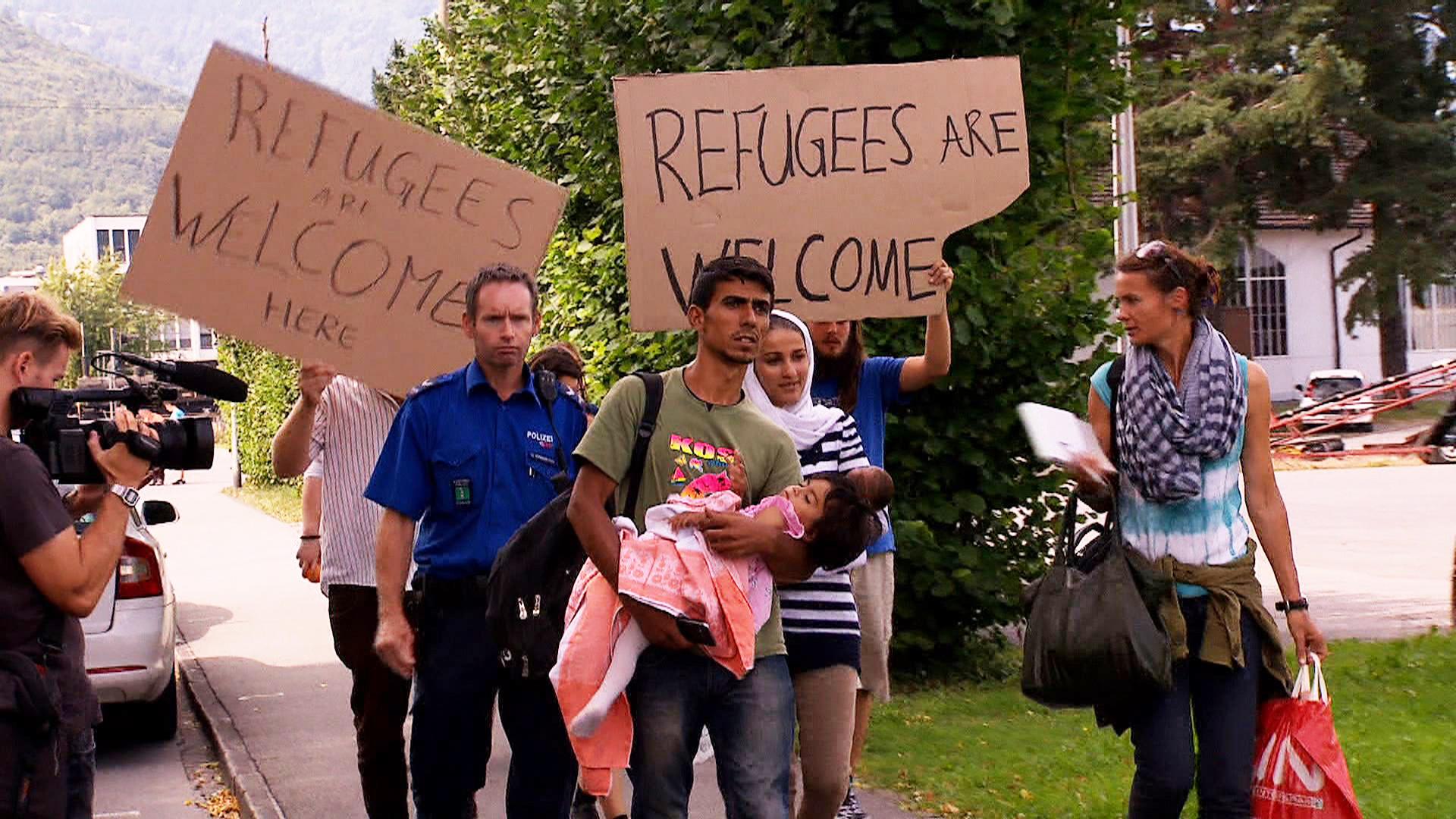 People welcome refugees at the border