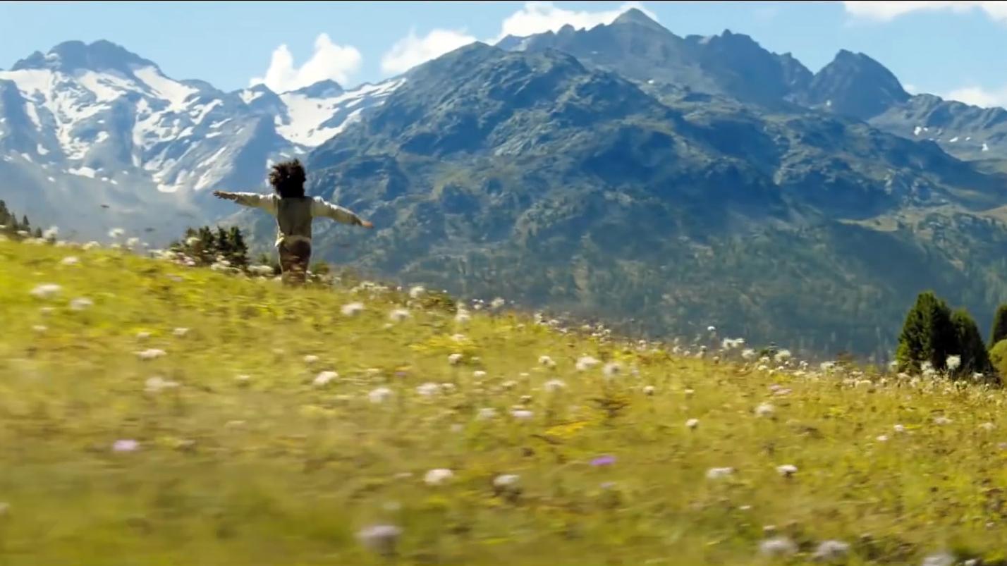 Heidi runs over a mountain meadow