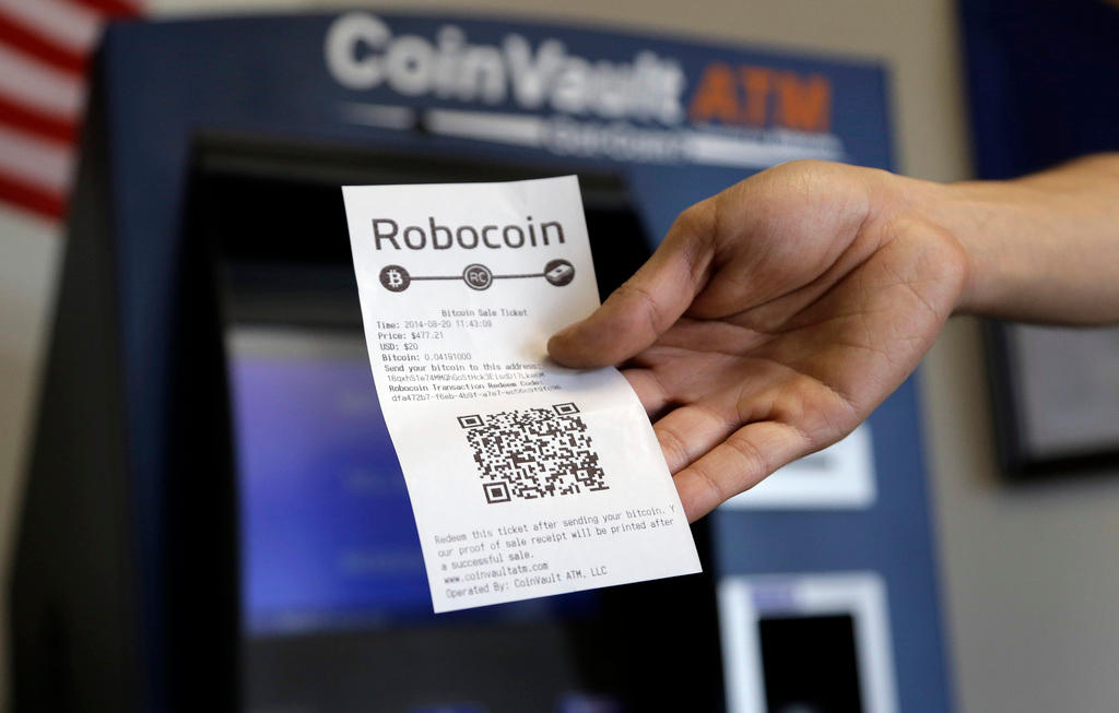 Bitcoin machine and hand holding receipt