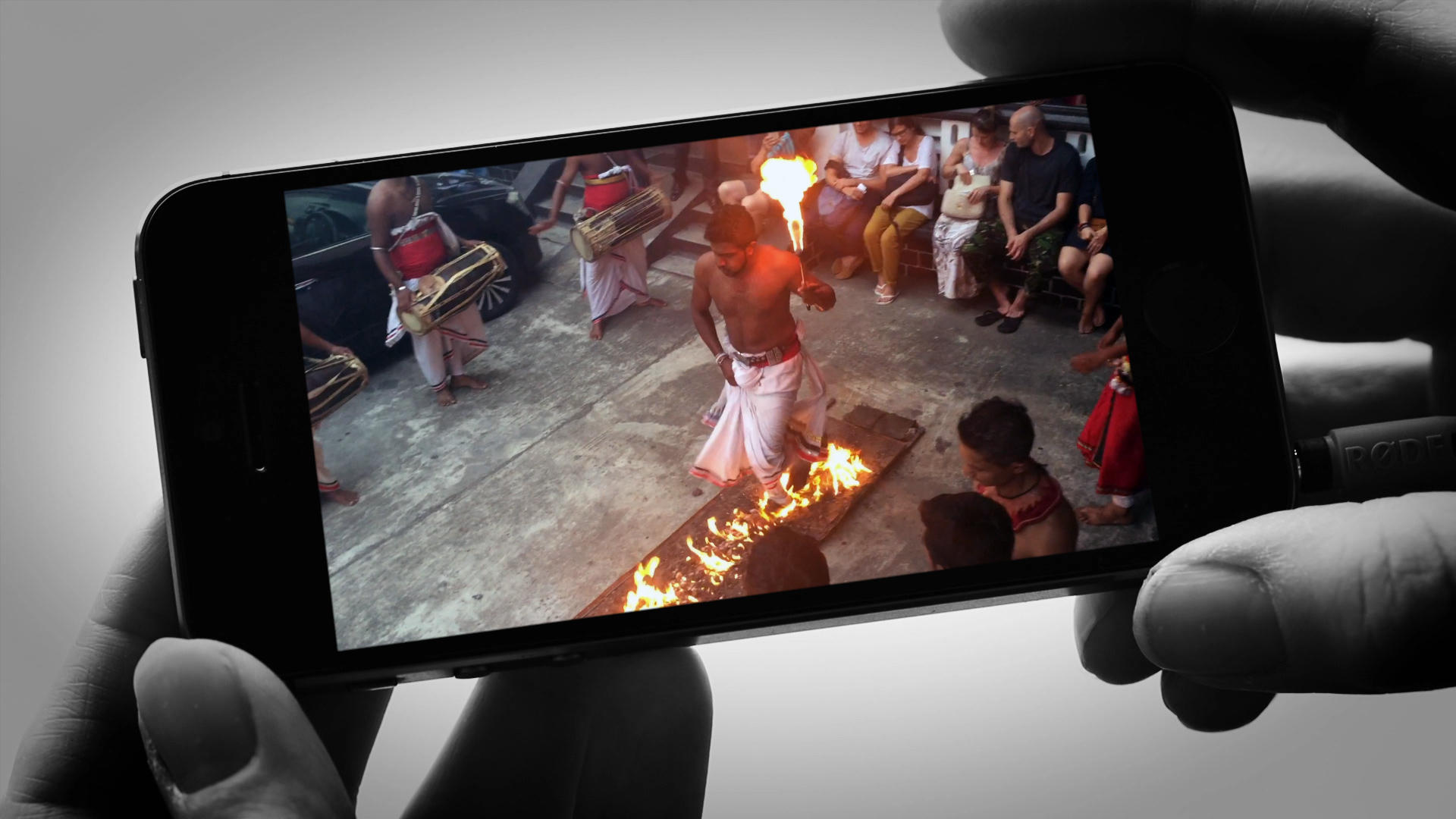 smartphone screen photographing a bonfire