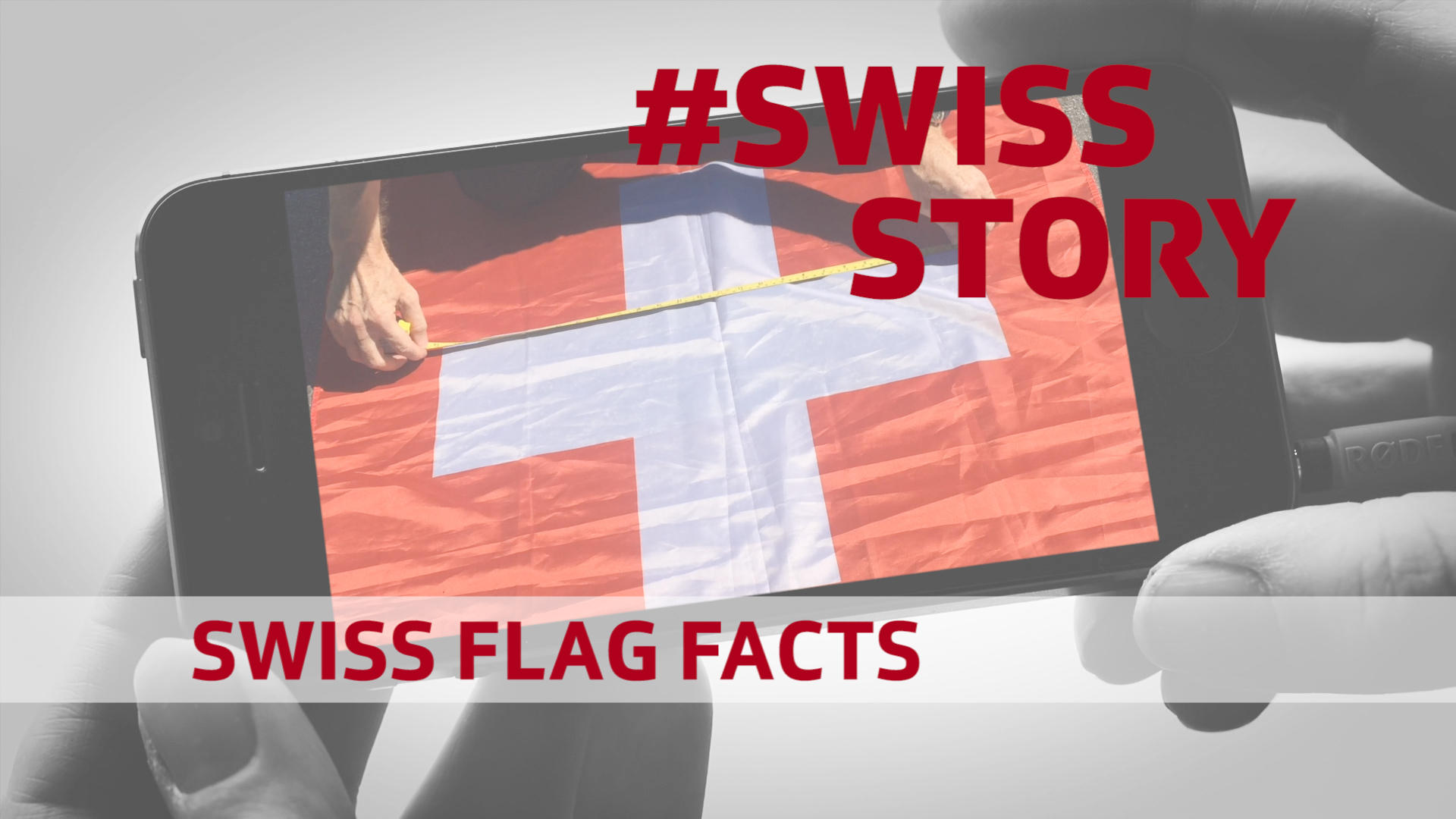 スマートフォンの上に映ったスイスの国旗