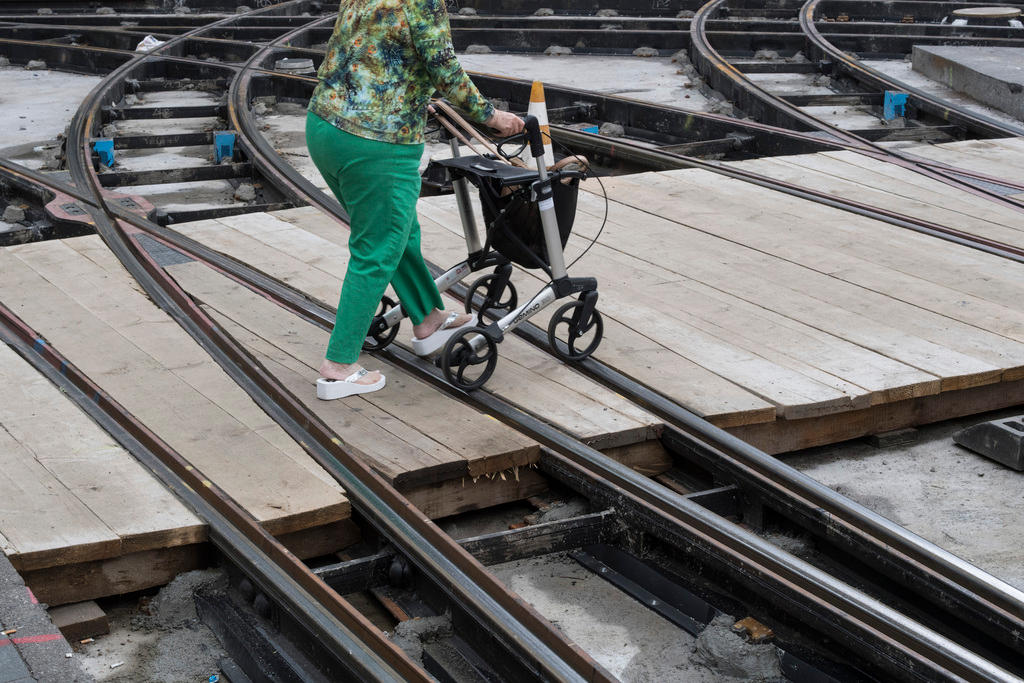 Woman walking across railway.