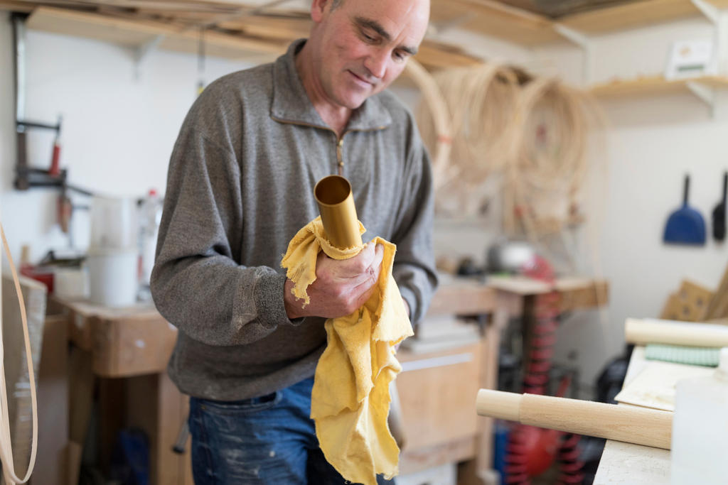 Thomas Eichenberger works on an Alphorn at his carpentry workshop in the canton of Lucerne.