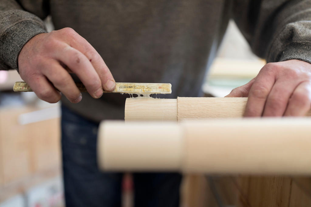 Thomas Eichenberger works on an Alphorn at his carpentry workshop in the canton of Lucerne.