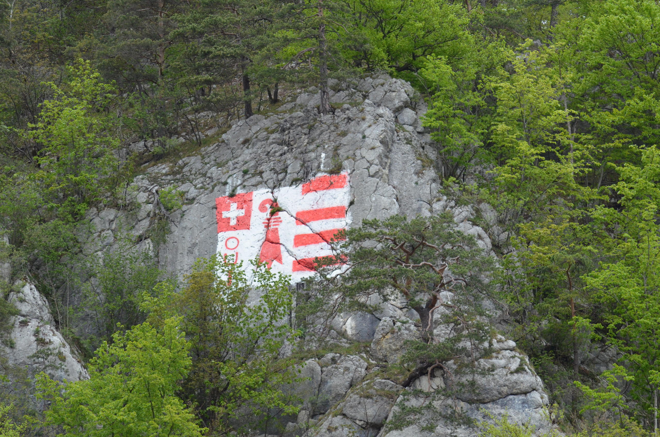 The flag of canton Jura painted on a rock above the village of Moutier