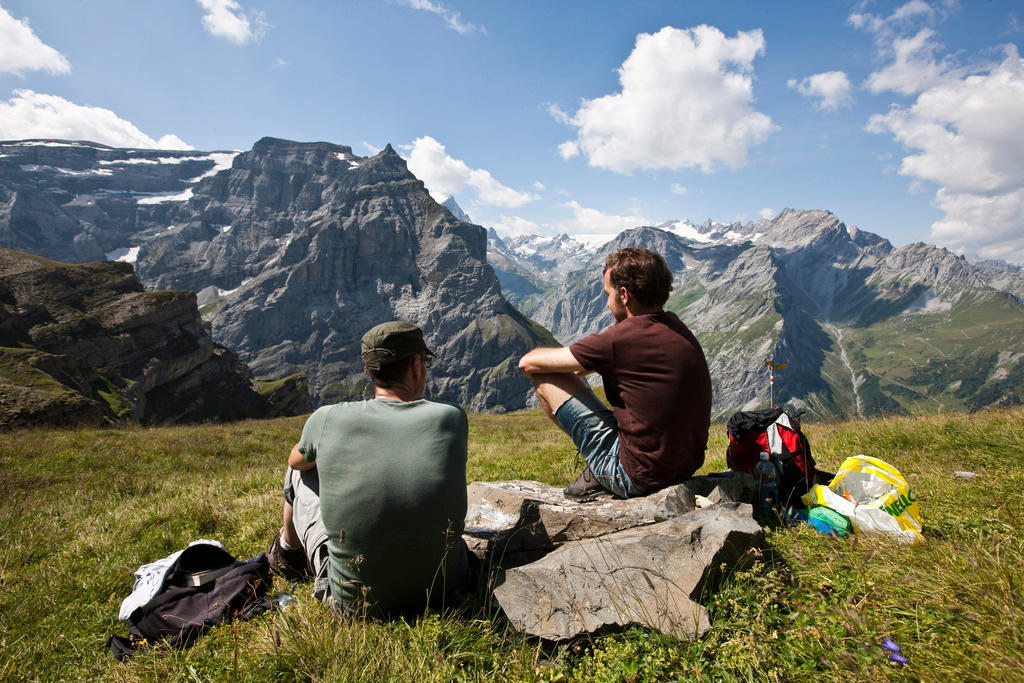 Two hikers rest above the Linth valley in canton Glarus