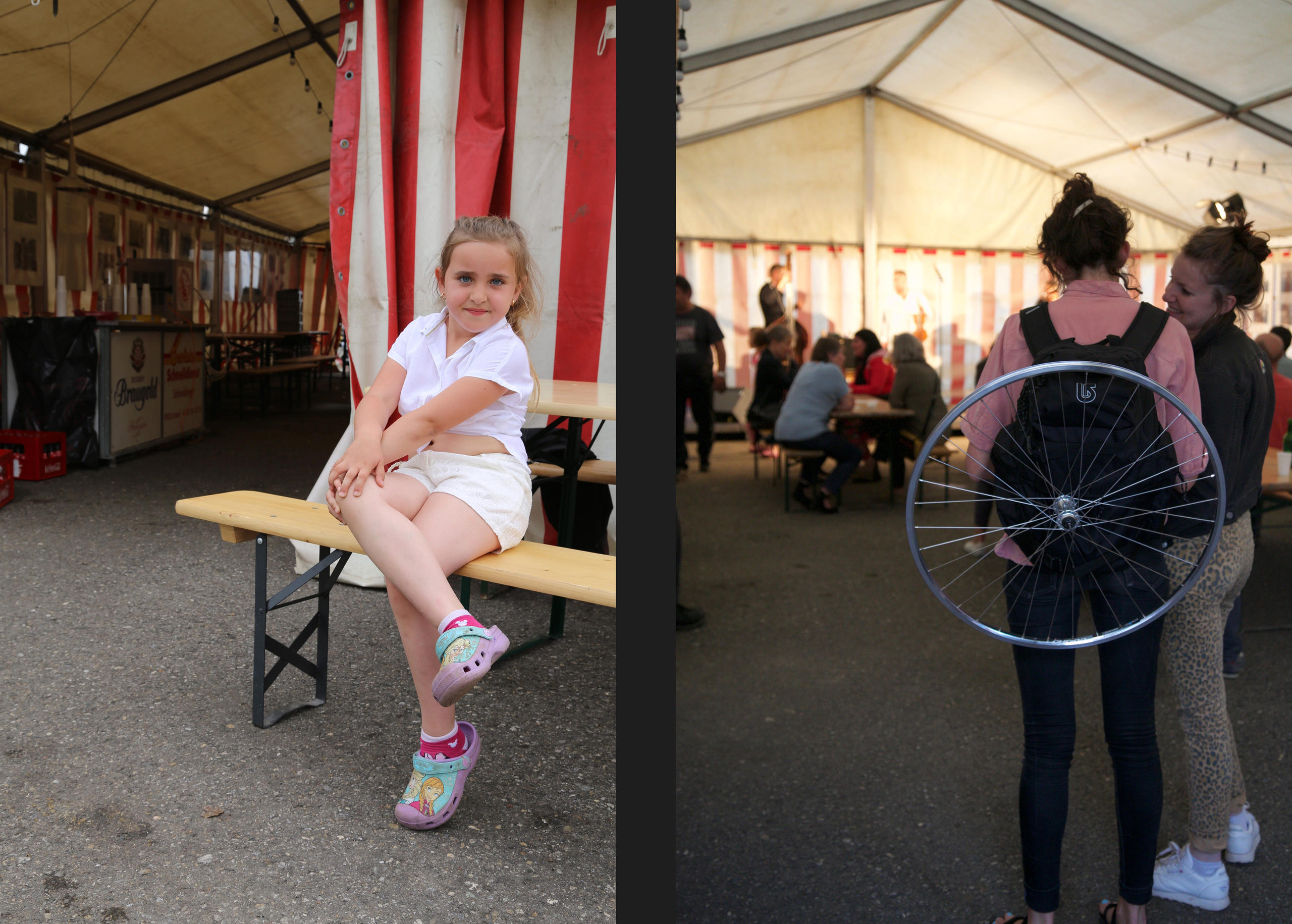 A young girl siting and posed on a bench looking to the camera and the backs of 2 women standing in a party tent.