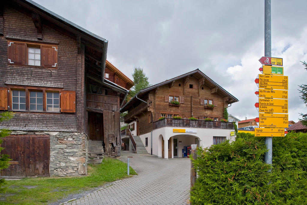 Hiking signs near the post office of Lumbrein in canton Graubünden