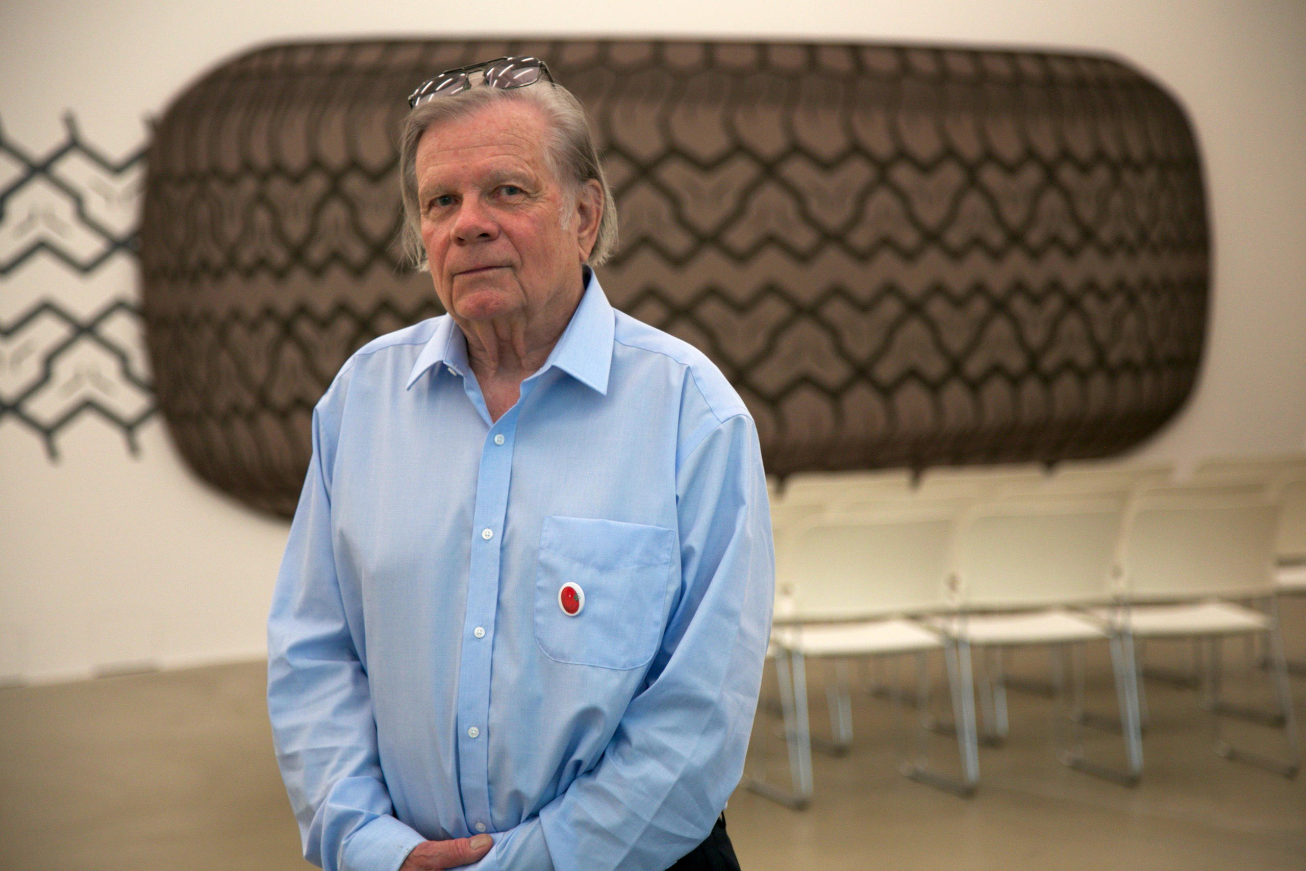 Peter Stämpfli, in front of his work of a giant tyre