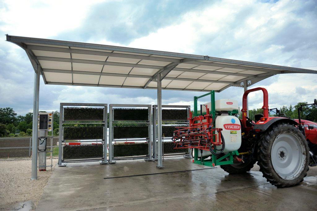 A tractor parked in front of a system used for purifying plants