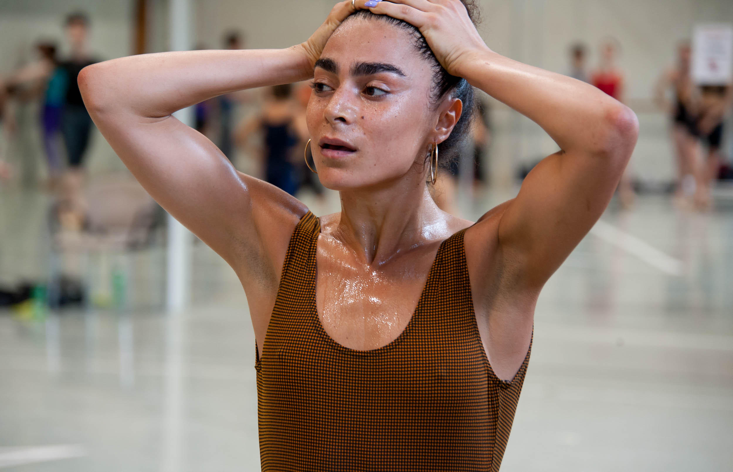 a dancer holding her head