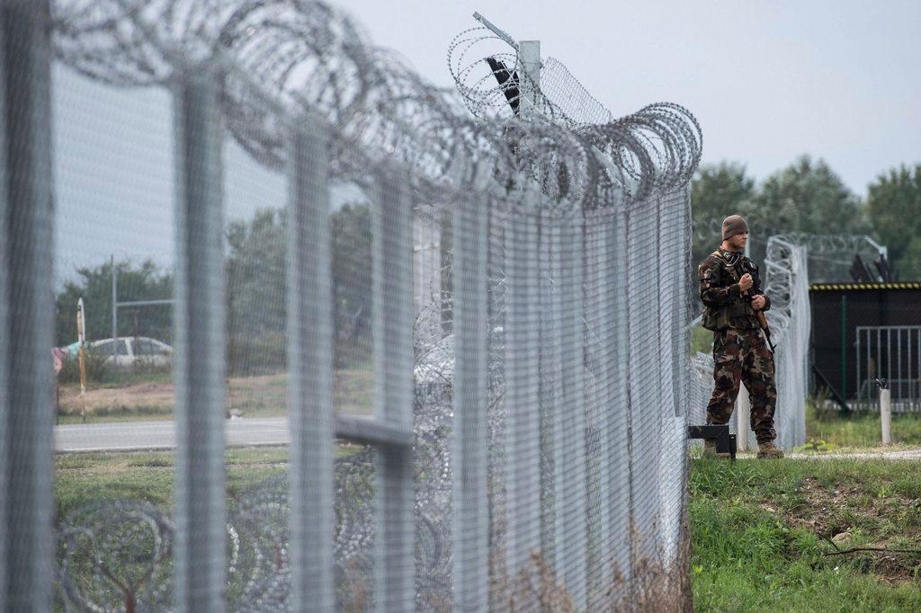 A Hungarian soldier patrols at the transit zone at Hungary s southern border with Serbia