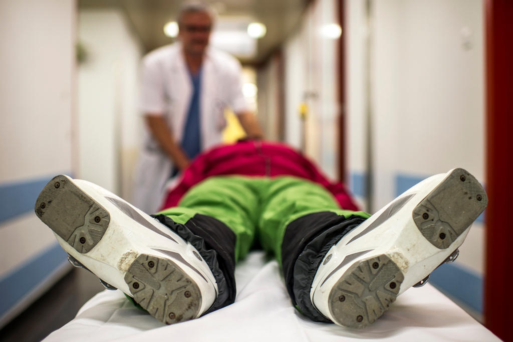 Injured man lies on bed in hospital