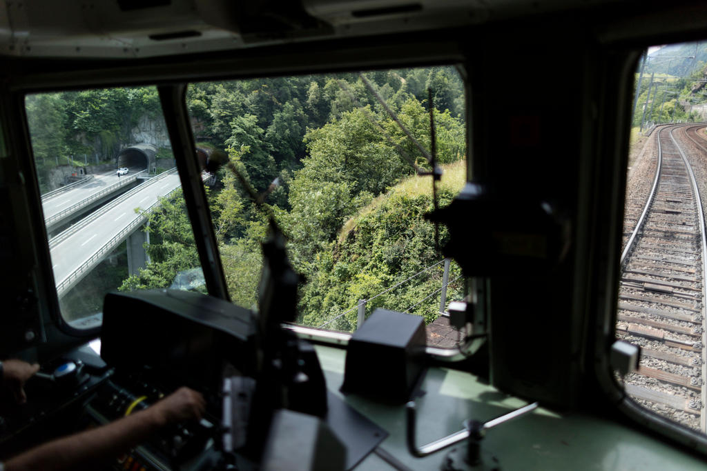 The dashboard and view of the tracks from the driver s seat of a Swiss train.