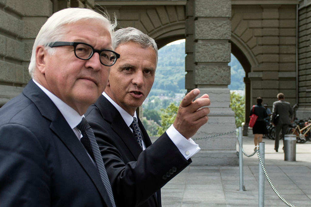 Didier Burkhalter waits on the red carpet for the arrival of German Foreign Minister Frank-Walter Steinmeier