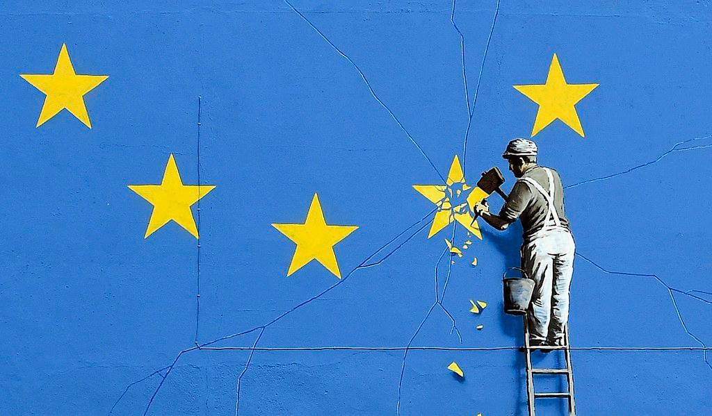 Close-up view of the Brexit-inspired mural by Banksy, showing a worker chipping away at a star on a EU flag