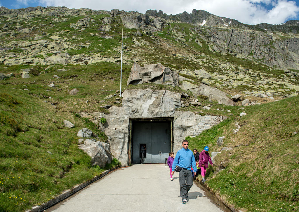 The entrance to a military bunker with visitors in the foreground
