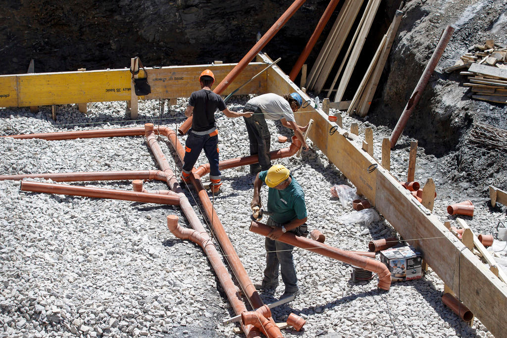 Workers on a house building site.