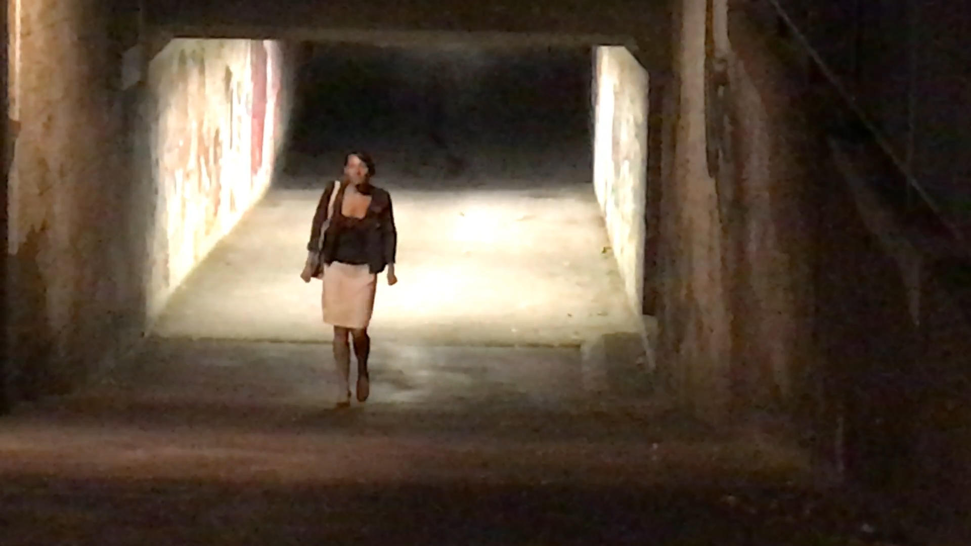 Lady walking through lonely underpass