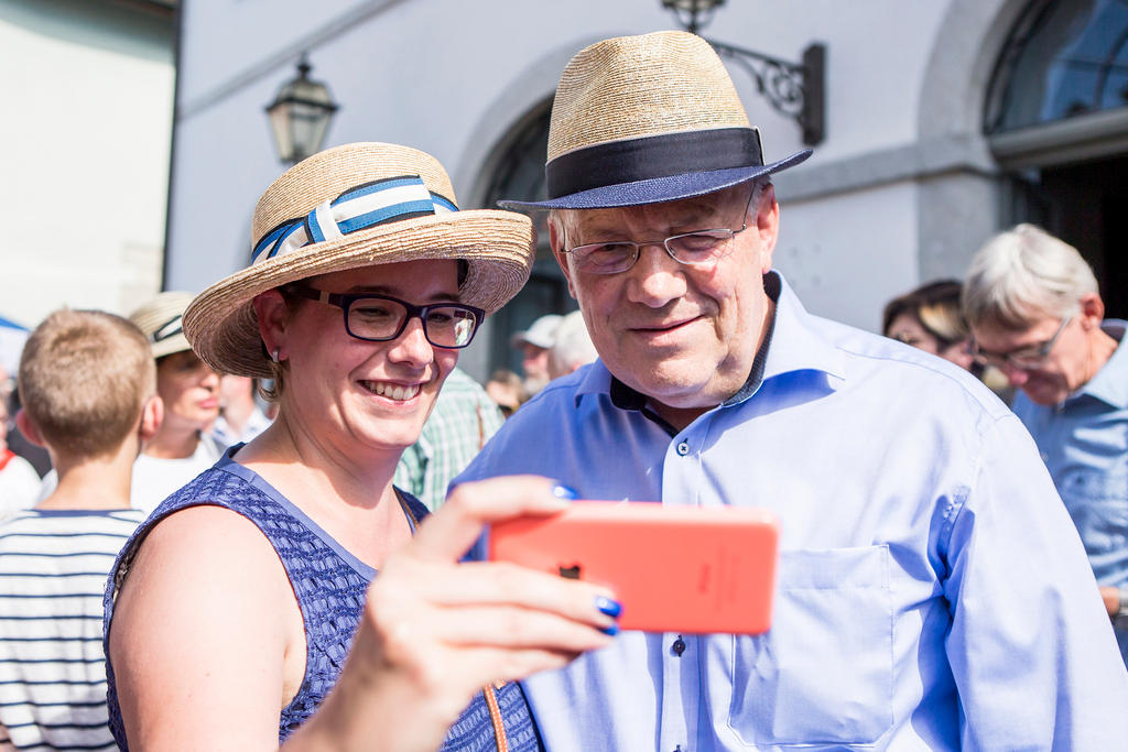 A woman takes a selfie with Swiss Economics Minister Johann Schneider-Ammann in Lenzburg