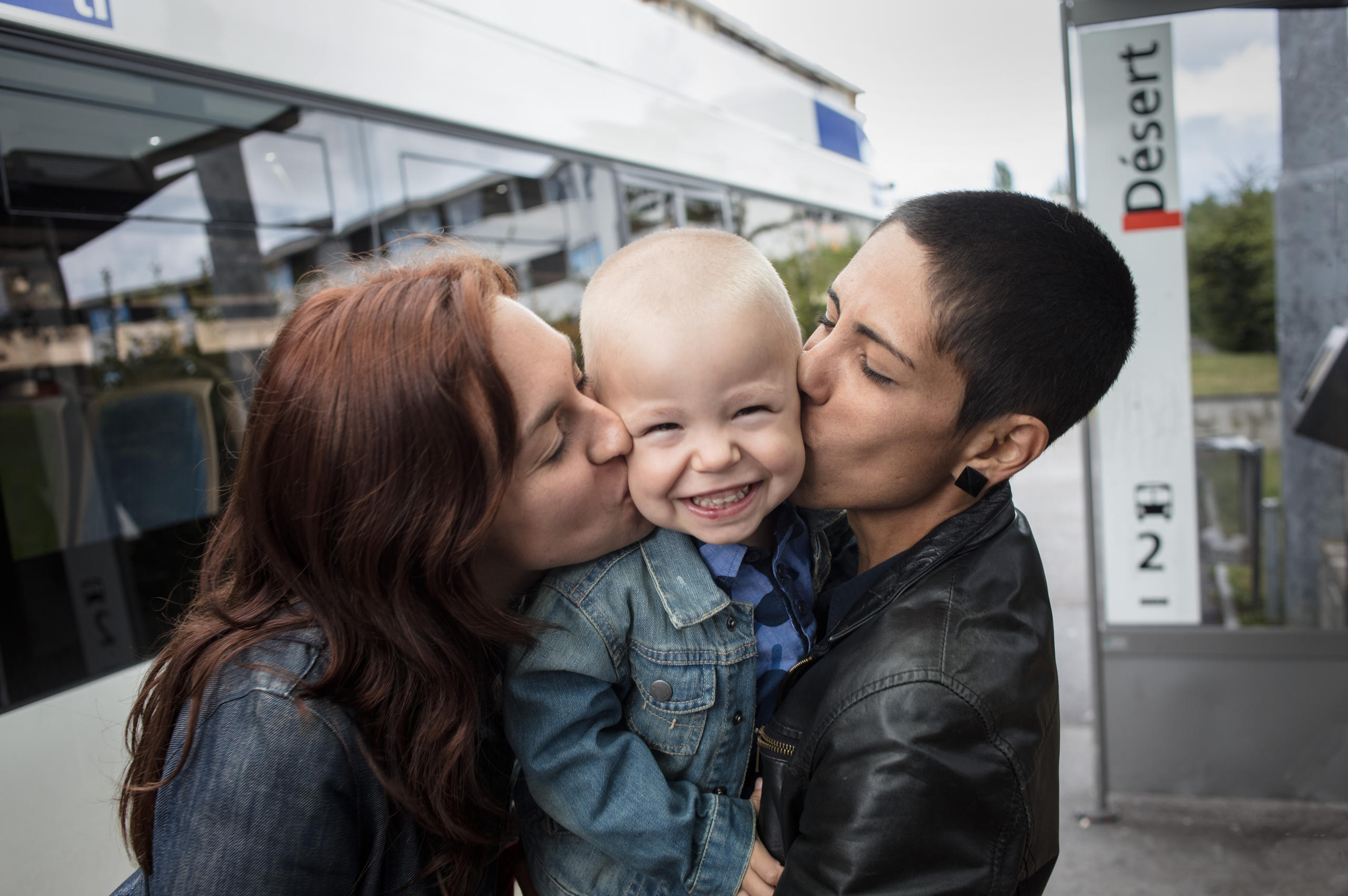 kissing couple with child