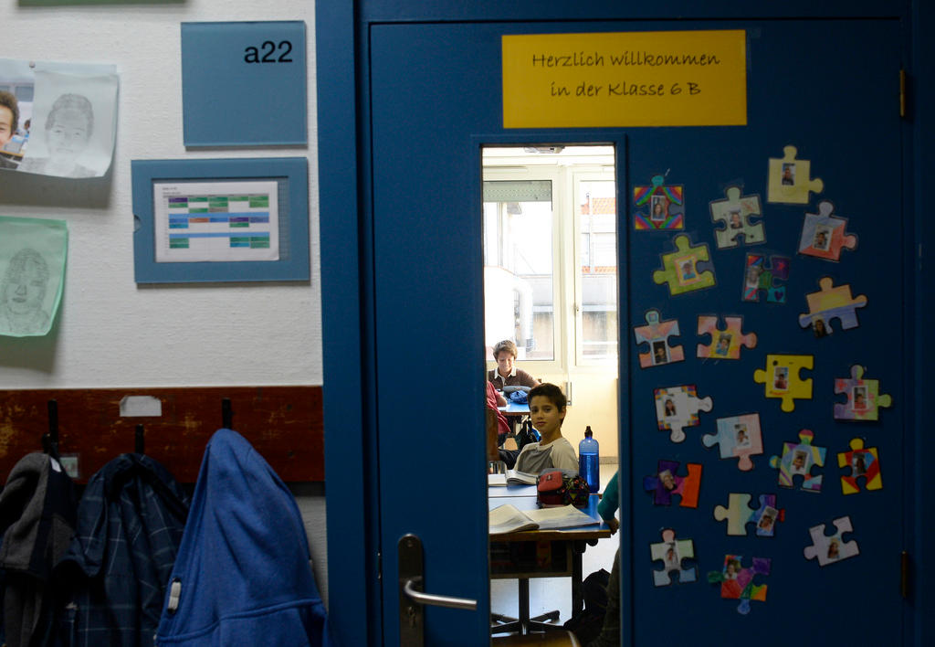 boy framed in window of school door