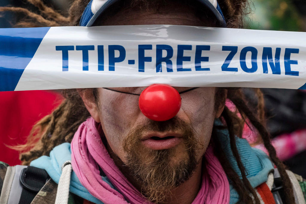 Demonstrator against international trade agreements wearing a red nose