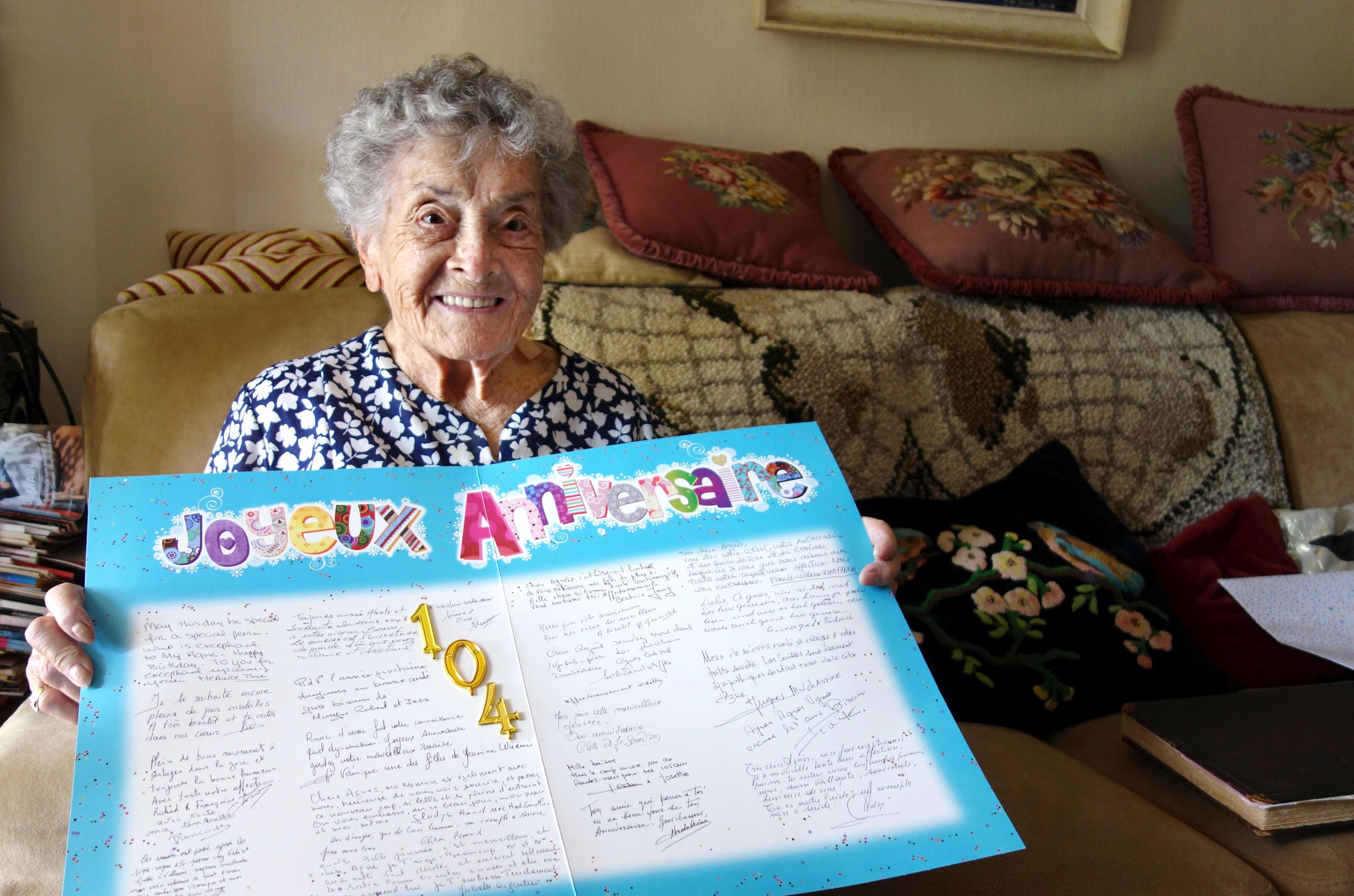 Agnes Parodi displays a card she received for her 104th birthday