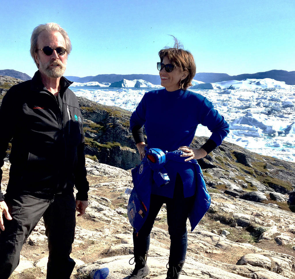 Man and woman with glacier behind them