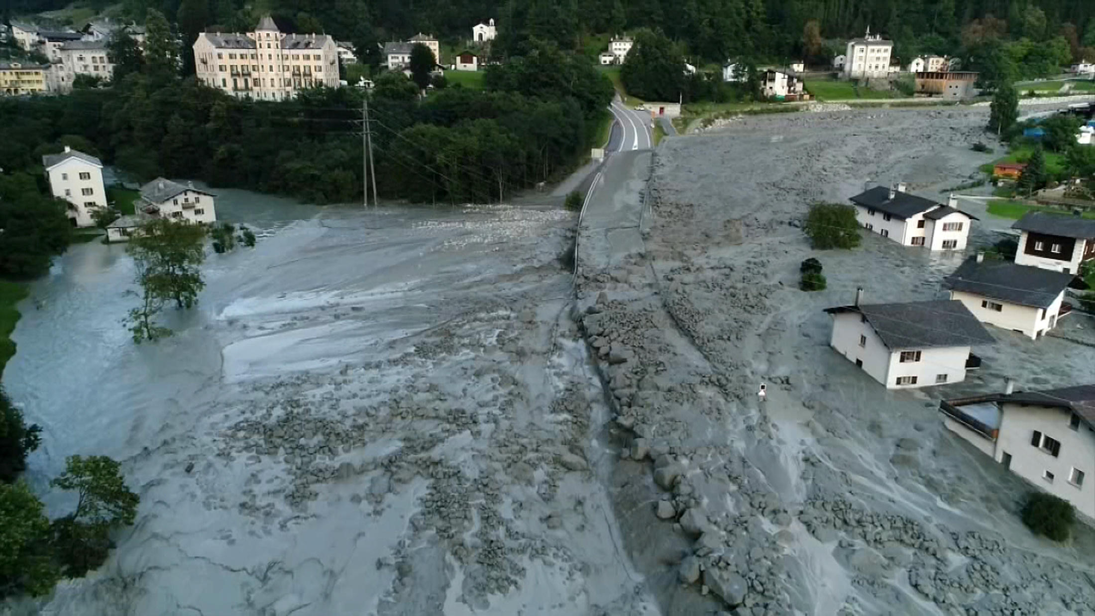 Houses are half covered by mud that has also swamped aroad