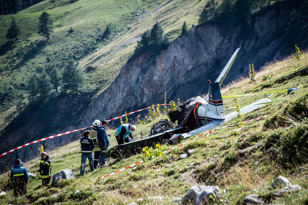 A rescue team works at the scene of a passenger plane crash at the pass of Sanetsch in Valais