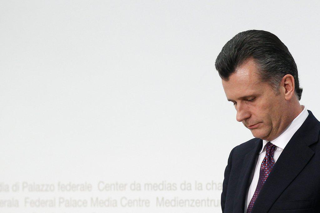 Philipp Hildebrand, in a dark suit, hangs his head in contemplation