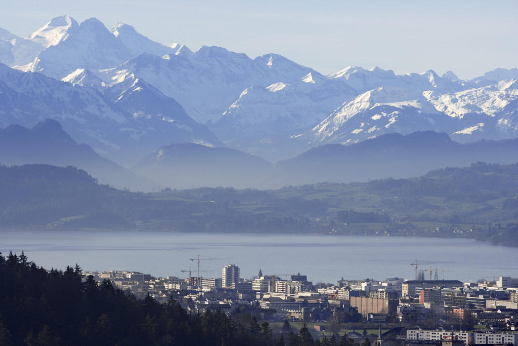 A town next to a lake framed by mountains