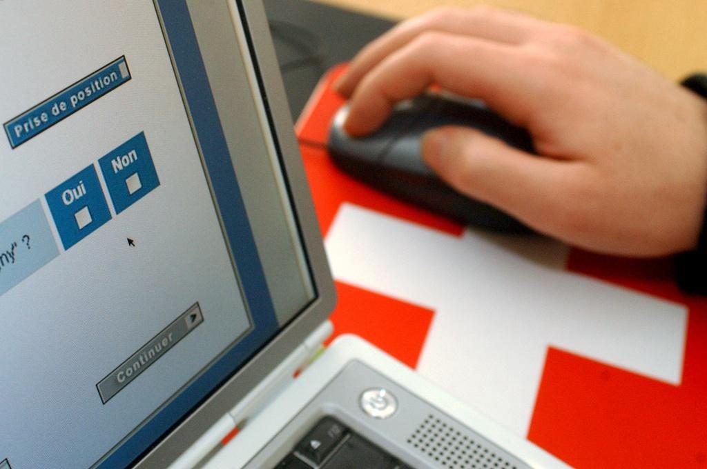 A man fills out his ballot online using a laptop computer