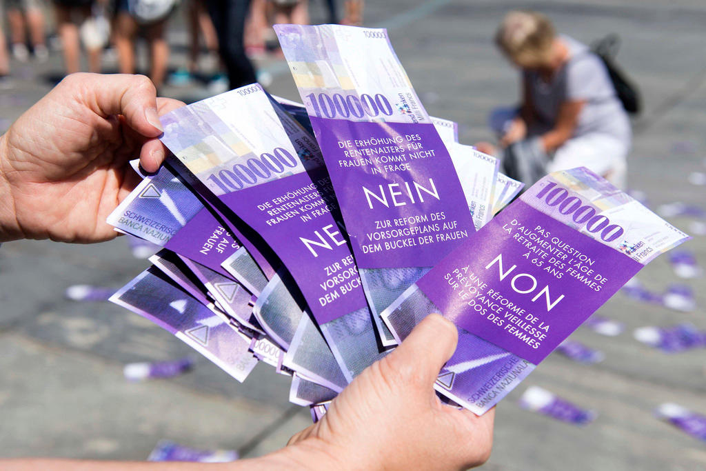 A pair of hands holds a number of purple vote leaflets