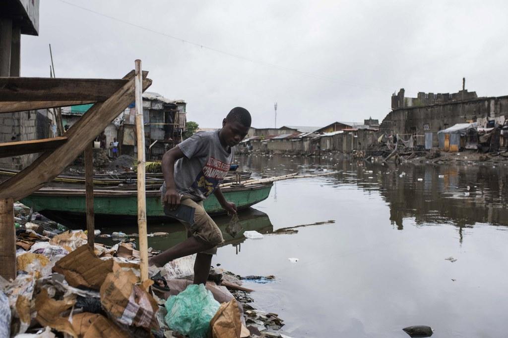 A young man walks along a flooded area with debris carried by strong winds in Cap Haitian, Haiti, 07 September 2017