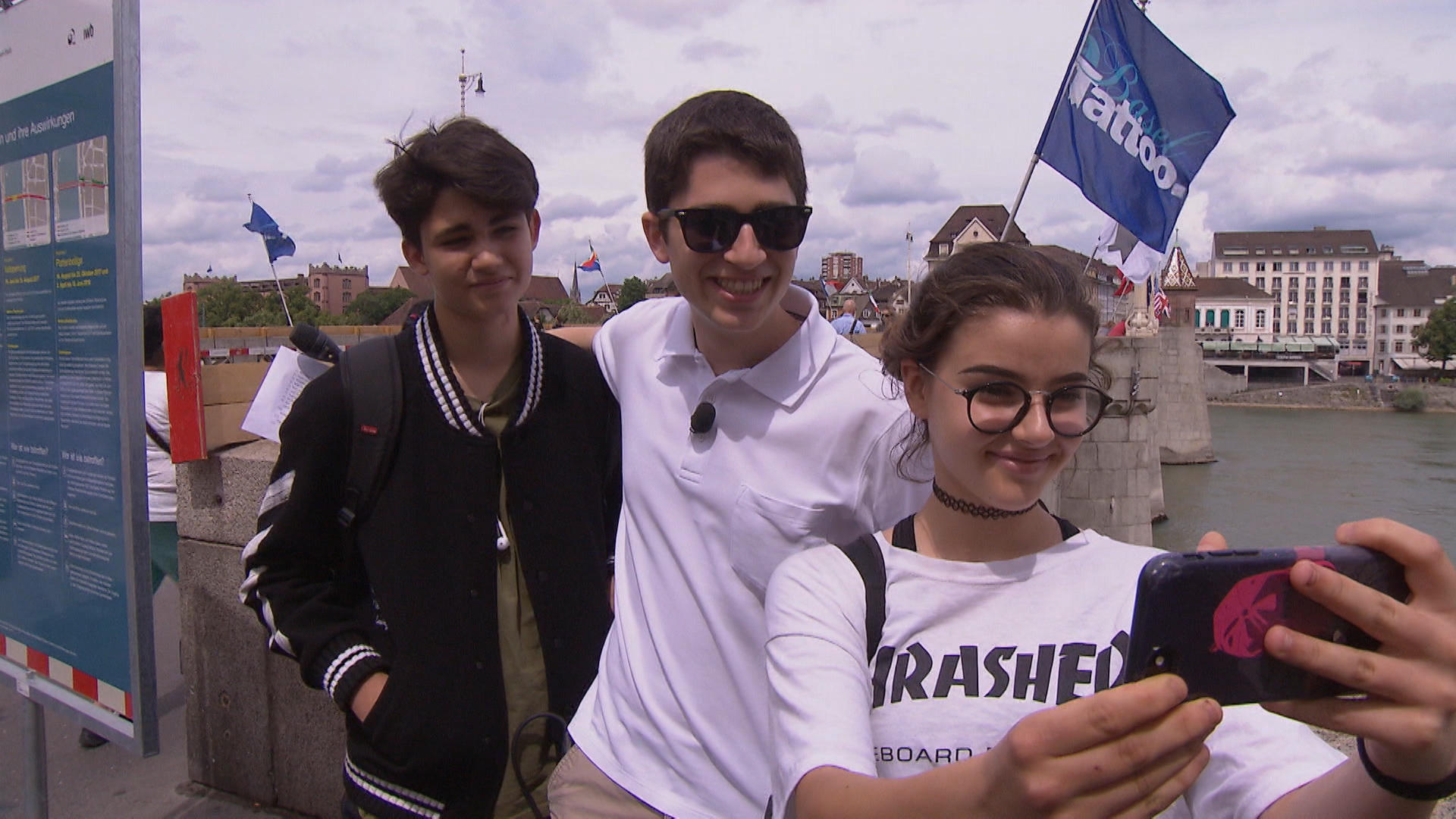 Basel youtuber with interviewees near river