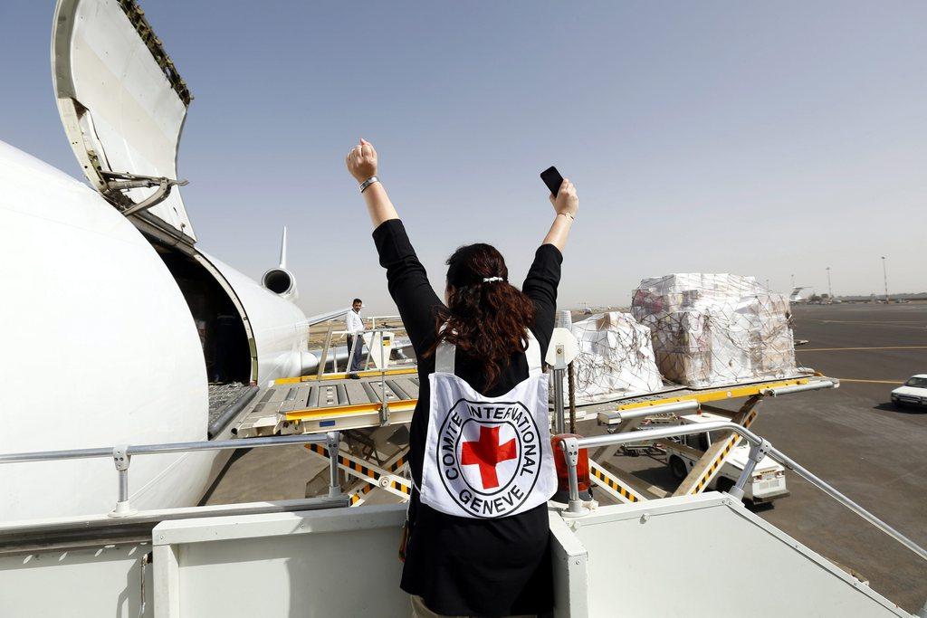 ICRC member at Sana a airport as medical supplies are unloaded